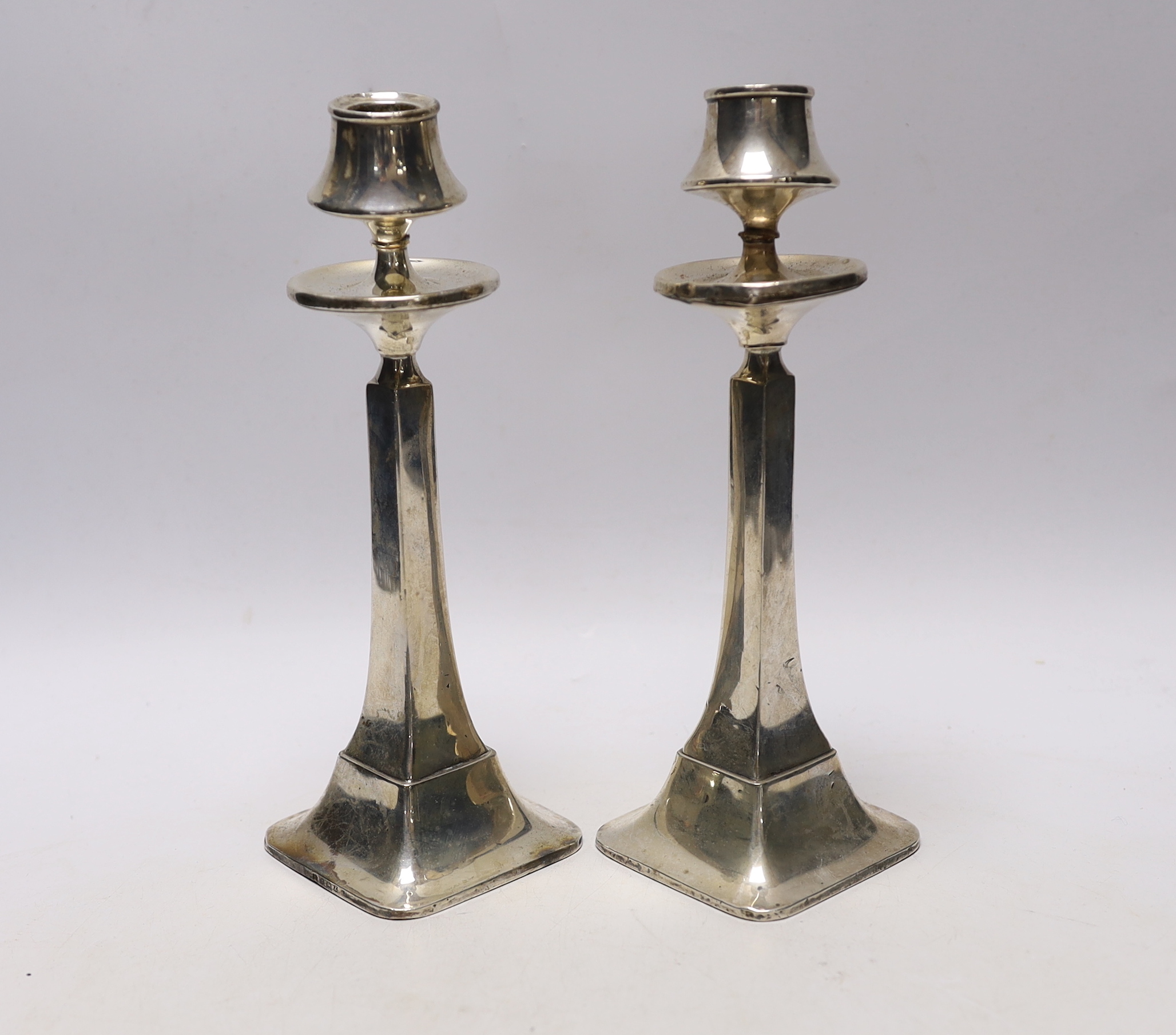 A pair of George V silver candlesticks, of tapering form, Charles S. Green & Co, Birmingham, 1924/25, height 22.5cm, weighted, (a.f.)